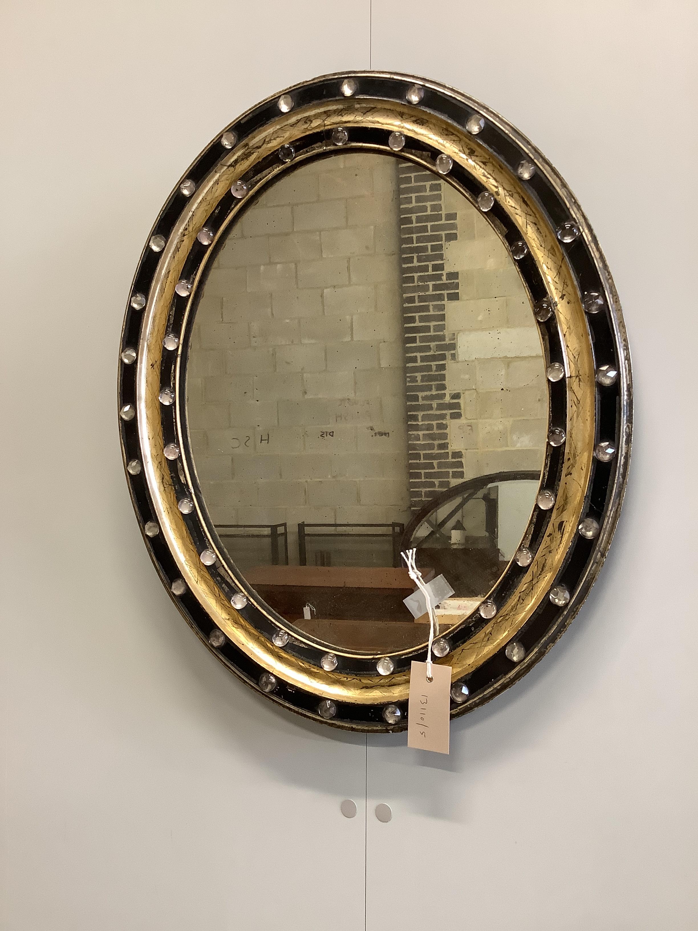 A small 19th century Irish oval wall mirror, with twin faceted and cabochon glass border, width 46cm, height 56cm